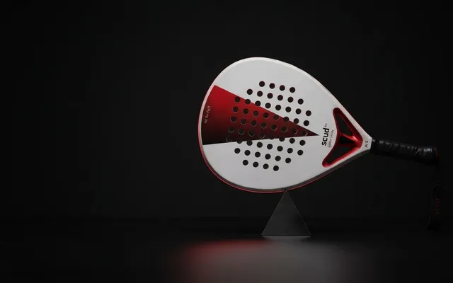 SCUD White S3 held level on a steel pivot against a black background: the balance point